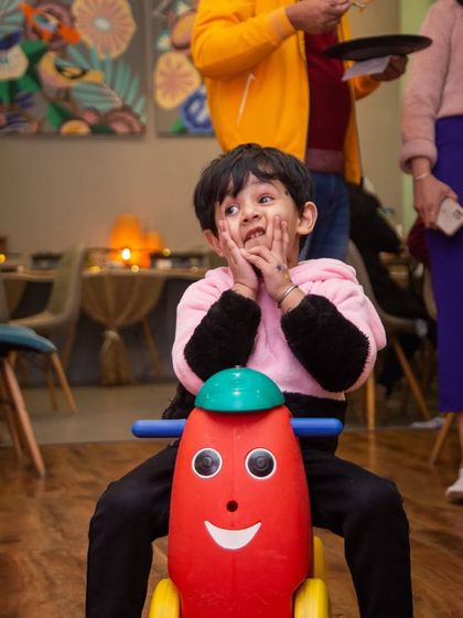 The look of pure delight while riding a smiley-faced toy. These simple moments of joy are what we're all about.