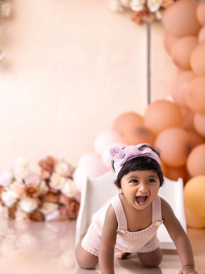 This little girl is crawling with excitement during her first birthday shoot. Her happy squeal is almost audible!