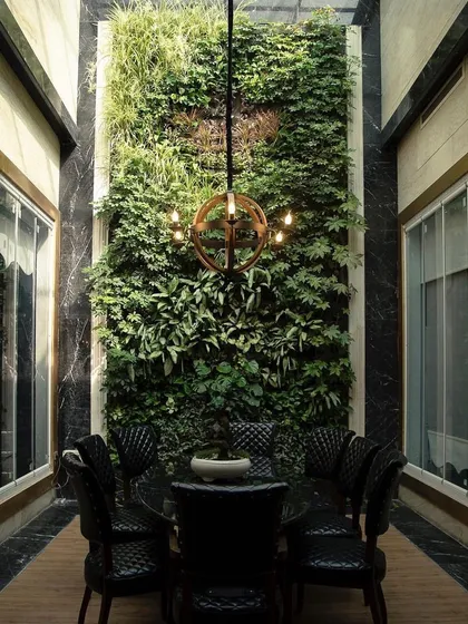 A green wall can transform an indoor space. In this dining area, I installed a floor-to-ceiling vertical garden under a skylight, bringing the freshness of the outdoors inside and creating a stunning, natural focal point for the room.