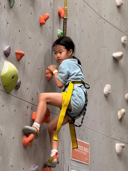 Every child gets to find their own path up the wall. This young climber is focused and determined, showing the confidence that climbing helps build.