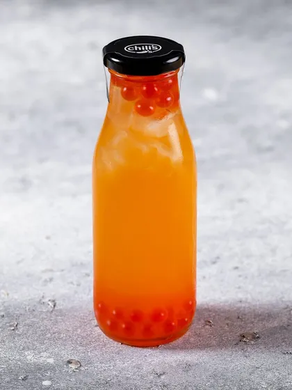 A bottled strawberry boba drink for Chili's India. The focus is on the vibrant color of the drink and the popping boba.