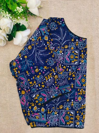 A navy blue cotton boatneck blouse with a colorful, intricate pattern.