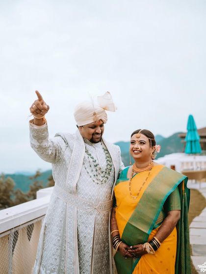 The couple enjoying the view from the balcony of their destination wedding venue in the mountains.