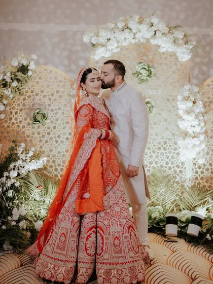 A sweet kiss on the forehead after the ceremony. We look for the quiet, loving gestures that happen right after the main rituals, capturing the couple's relief and happiness.