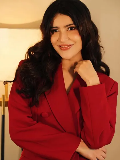 A softer, smiling shot that shows the versatility of this makeup look, suitable for both serious and playful moods.