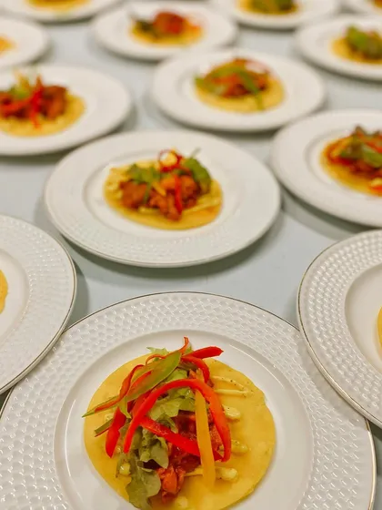Our food is a feast for the eyes as well as the palate. These vibrant Chicken Garlic Mini Tacos, artfully plated, represent our modern approach to Indian fusion cuisine, where familiar flavors are presented with contemporary flair.