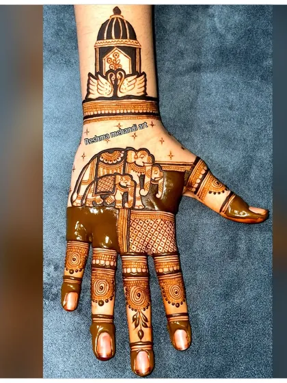 I love the elegance of traditional Rajasthani mehandi. This design features a royal elephant procession on the palm with a palace dome and swan motifs on the wrist, all done with super fine lines.