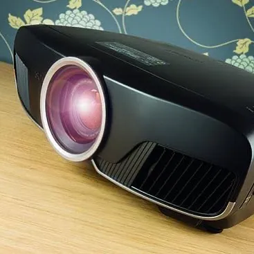 A detailed look at the lens assembly of an Epson TW9400 home cinema projector. We select equipment like this for its superior optics, which are essential for achieving true 4K sharpness and clarity.
