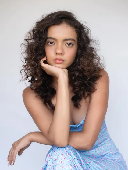 A beachy, sunkissed look with messy, natural-looking curls. The makeup is kept minimal to enhance the effortless, summery feel.
