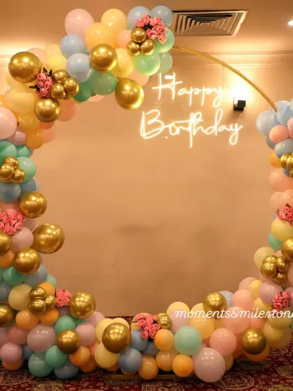 Our custom balloon rings are a client favorite. For this candy-themed party, we created a full circular arch with pastel and gold balloons, accented with small floral details. The "Happy Birthday" neon sign in the center adds a modern, celebratory glow, perfect for photos.