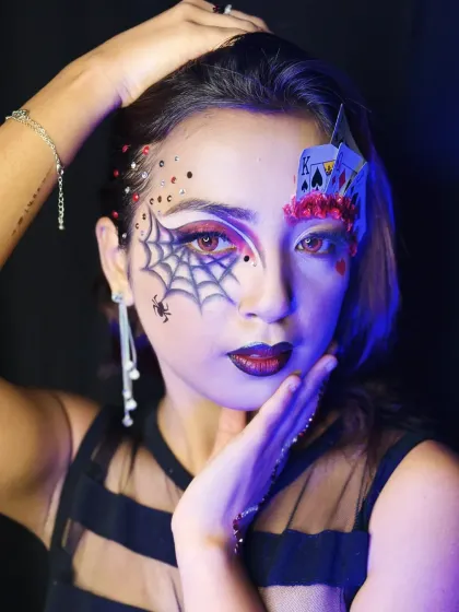 A close-up under dramatic lighting, showing how the makeup interacts with different light sources.