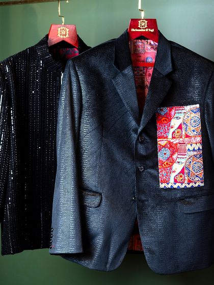 Our bespoke services cater to a wide range of styles, from understated to bold. This image displays two distinct statement jackets: one in a shimmering black sequined fabric and another in a textured material with a uniquely patterned pocket detail.