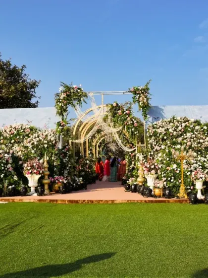 A wide view of the floral entrance, showing how it creates a stunning focal point in the landscape. The design is meant to look like a natural extension of a beautiful garden.