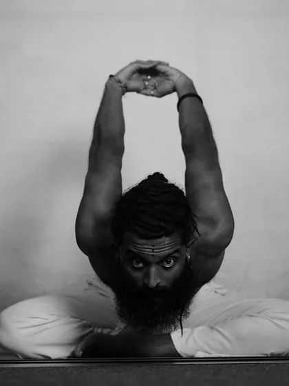 A deep forward bend in Baddha Konasana (Bound Angle Pose). This pose reflects the wisdom of the Bhagavad Gita: to remain steadfast and treat success and failure with equanimity. This state of balanced mind is yoga.