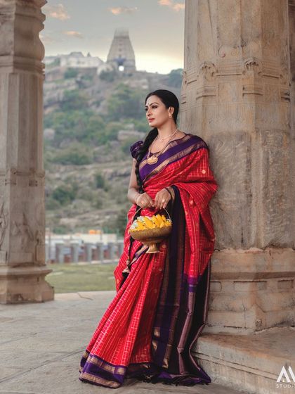 A full-length shot showcasing the saree against the backdrop of the historic temple, a perfect blend of fashion and heritage.