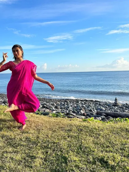 Another angle from the seaside shoot, capturing a joyful and free-spirited dance movement. This shows how I can create a variety of shots and moods within a single location and outfit.