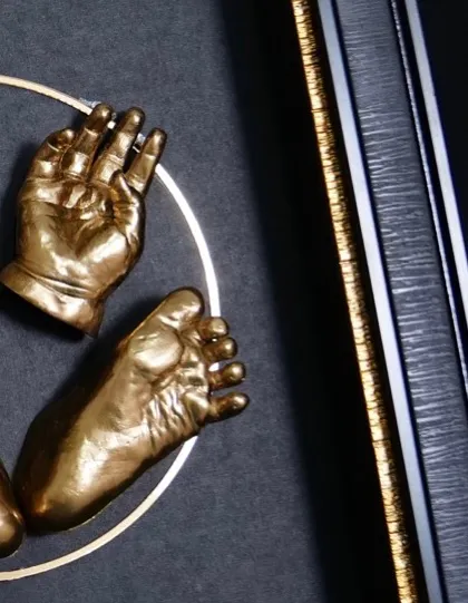 A close look at the fine details you will master. This image highlights the smooth, golden finish on the baby hand and foot impressions and the clean, professional look of the shadow box framing, skills that set your work apart.