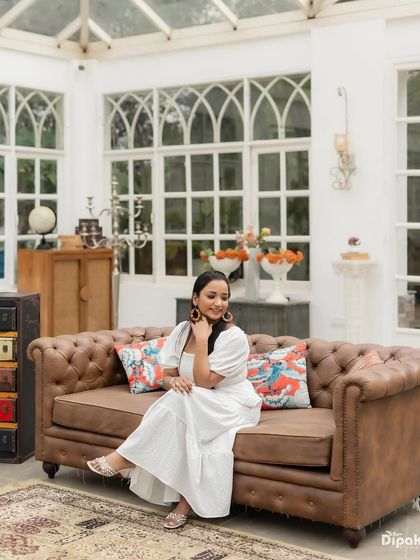 A full shot showing a casual and comfortable pre-wedding look. The makeup is natural and enhances her features without being heavy.