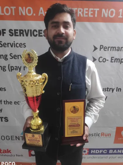 This is me with a trophy and a plaque from a recent championship. I lead by example, showing my students what is possible with hard work.