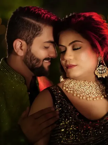 A dramatic and passionate portrait using colored lighting. The red light adds a touch of fire and intensity to this intimate moment, highlighting the couple's chemistry.