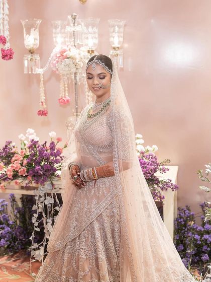A quiet moment for the bride amidst the beautiful decor. Her soft makeup looks serene and elegant.