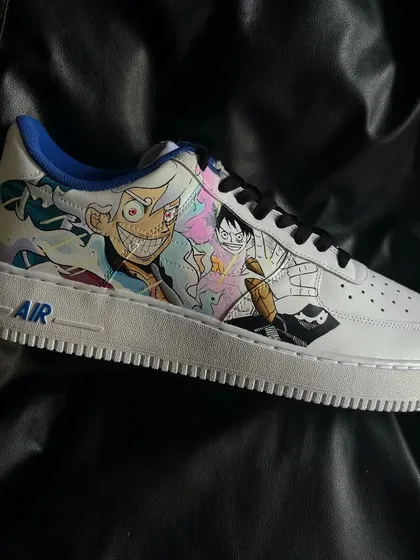 A side view of the Luffy-themed sneaker from the One Piece custom pair, showcasing the detailed character art.