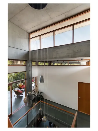 A view from the upper level looking down into the light-filled atrium, showcasing the interconnectedness of the different floors.