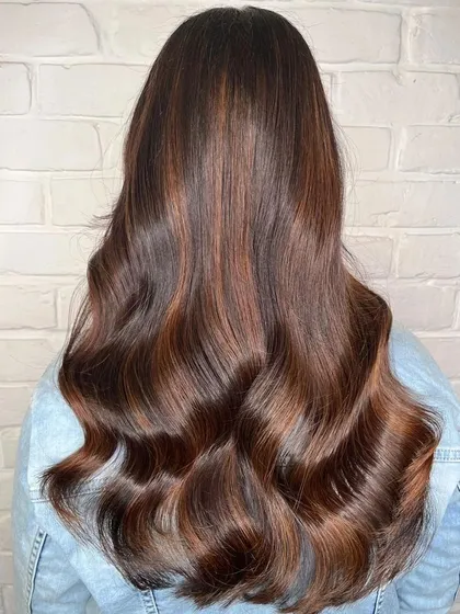 A beautiful example of a copper and golden brown balayage. I hand-painted these highlights to create a warm, dimensional effect that shines from every angle, styled here with soft waves.