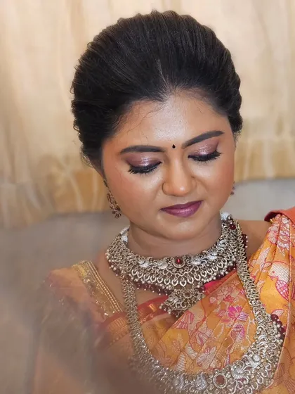 A close-up of a bride's soft and timeless look. The peachy tones on her cheeks and the champagne shimmer on her eyes create a romantic feel.