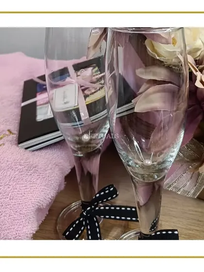 A pair of elegant champagne glasses, ready to be included in a celebration hamper for the bride. Perfect for toasting to her new beginning.