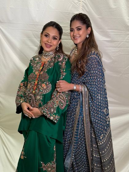 The two beautiful sisters together, one celebrating her baby shower. Their complementary makeup looks are elegant and timeless.