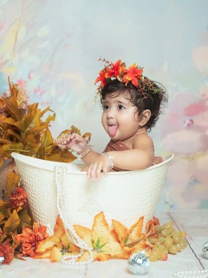 A playful tongue-out moment during a water splash session. These are perfect for capturing your baby's fun-loving side.