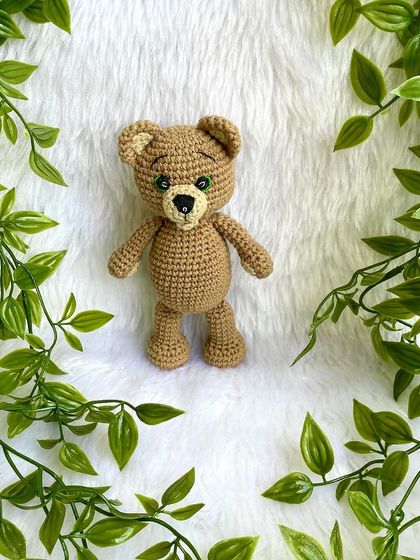 A classic teddy bear, a timeless gift for any age. This one is shown with a red ribbon, a black tie for 'Daddy Bear', and with expressive green eyes. They are soft, cuddly, and made to be loved.