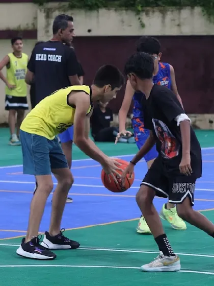 Two young players battle for the ball. This drill teaches aggressiveness and ball security, essential skills for any competitive player.
