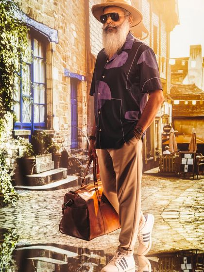 This European street scene, created with projection, provides a classic, timeless backdrop for this men's fashion shot. The lighting mimics natural sunlight filtering through buildings.