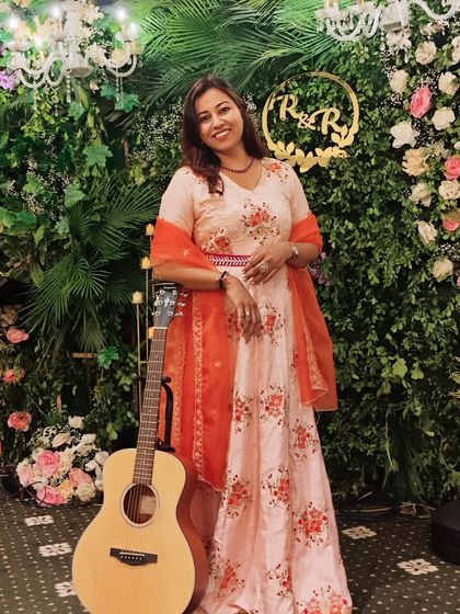 Posing with a guitar against a stunning green wall. It's all about capturing the vibe of the event.