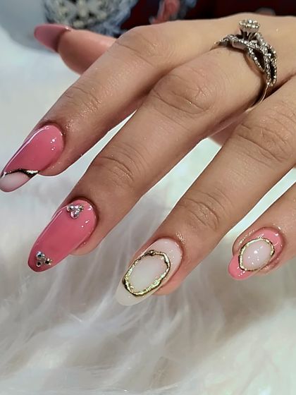 A side profile of the pink and gold framed nails, showing the dimension and artistry of the design.