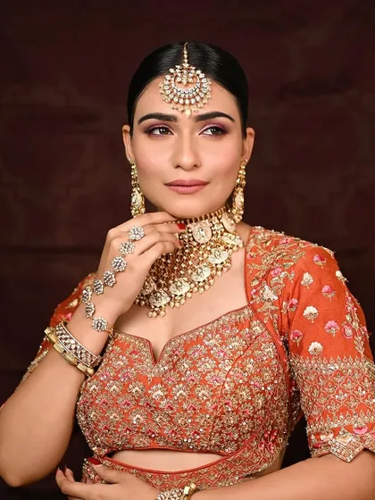 A classic pose showcasing the intricate bridal jewelry and the clean, radiant makeup that enhances her natural beauty.