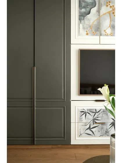 A close-up of the custom wardrobes in the den. The hand-painted detailing and integrated TV unit showcase our ability to blend art, technology, and storage seamlessly.