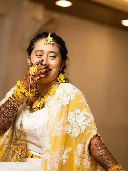 A candid photo capturing a moment of laughter and joy during the mehndi celebration.