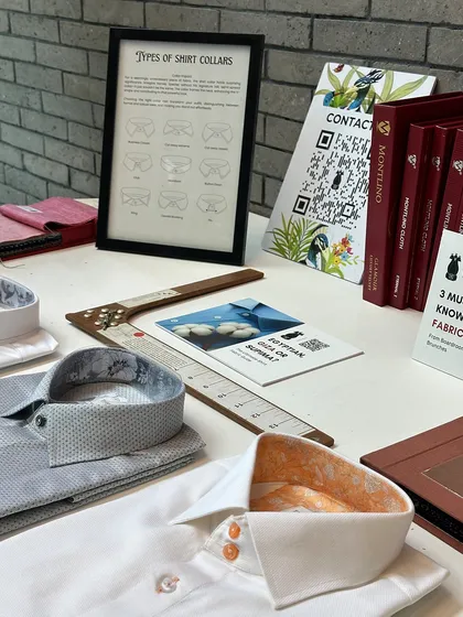 A table of our custom shirt offerings at the BCG trunk show. Details like contrasting inner collar fabric and custom button colors allow for true personal expression.