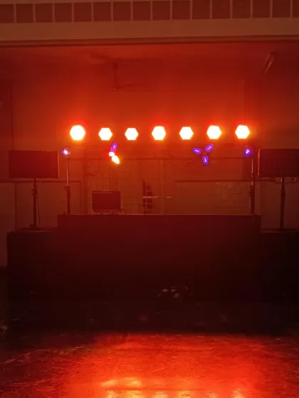 My DJ console ready for action, backed by a truss loaded with professional PAR can lights. The right lighting is key to creating the perfect party atmosphere.