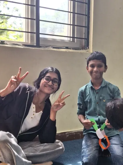 A volunteer and child pose with peace signs during the Republic Day craft session. It was a day of learning, dreaming, and building friendships.