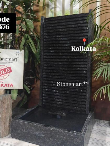 A straight-on shot of the 3-foot granite waterfall, highlighting the texture of the ribbed panel.