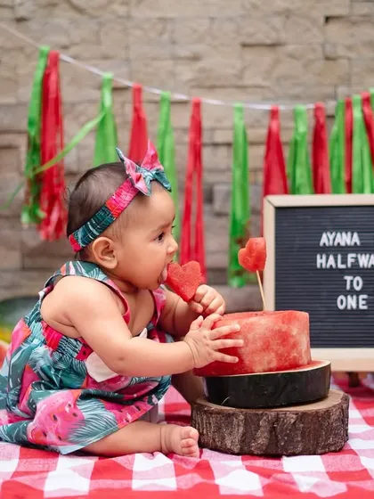 Celebrating six months with a sweet and juicy watermelon smash. This is a fun, colorful, and unique alternative to a cake smash, perfect for capturing that "halfway to one" milestone.