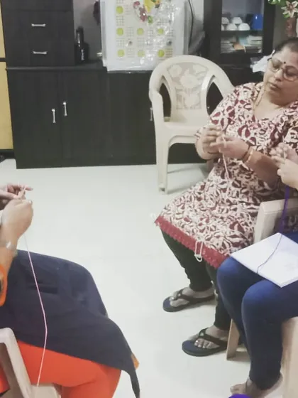 Here you can see a typical class setting where I'm helping two students at once. We create a comfortable, friendly atmosphere where everyone can learn at their own pace and feel supported.