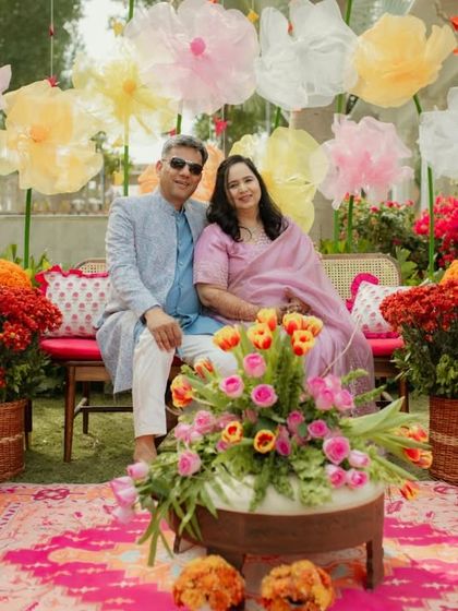 Family members posing in the beautiful floral photo area, a perfect keepsake from the celebration.
