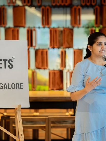 A performer gestures as she speaks, bringing her poem about "Seasons" to life.