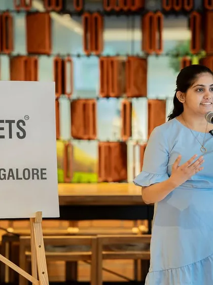 A performer gestures as she speaks, bringing her poem about "Seasons" to life.