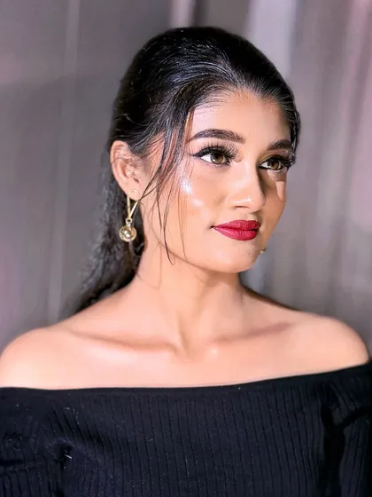 A full-face view of the sleek and modern 'glass skin' makeup look.